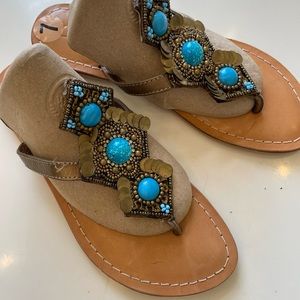 Thong sandals with turquoise beads .